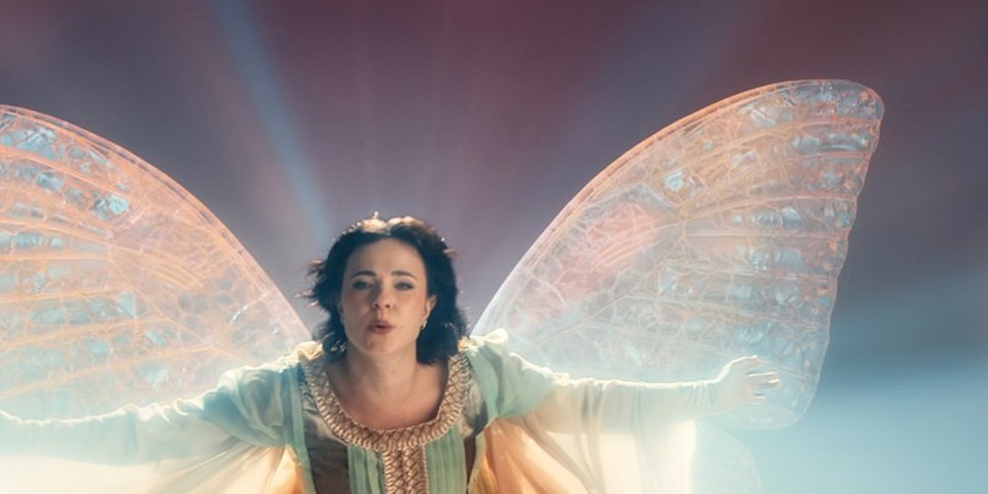 A dark-haired woman in a mint and gold gown hovers with translucent fairy wings in official Fablehaven test footage