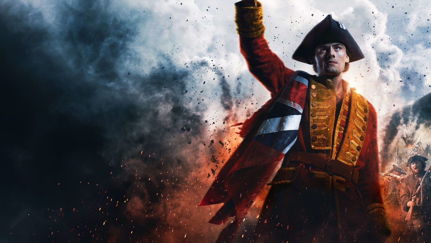 William Franklyn-Miller as young George Washington in a red British coat with a Union Jack across his chest, arm raised in smoke and embers