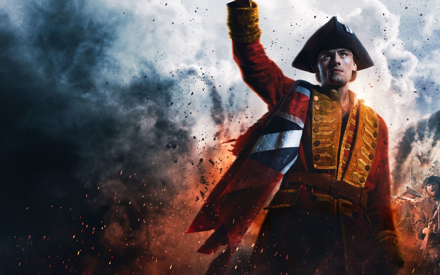 William Franklyn-Miller as young George Washington in a red British officer coat, Union flag across his chest, arm raised in smoke